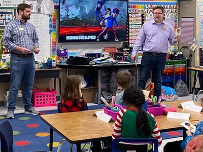 A volunteer teaching students in a classroom